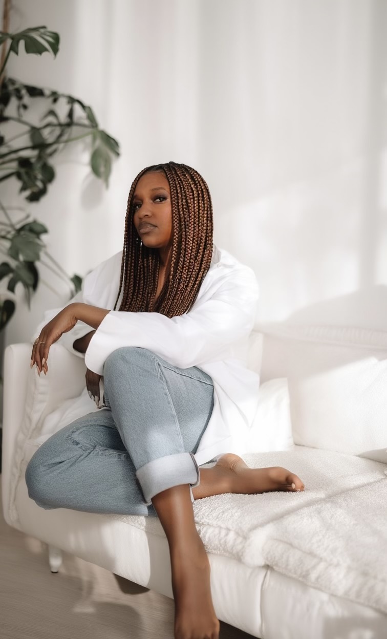 Haleema McCree seated thoughtfully in a bright studio